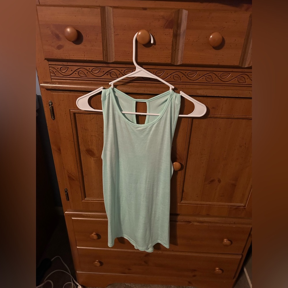 Light blue tank top with criss-cross back. New without tags.